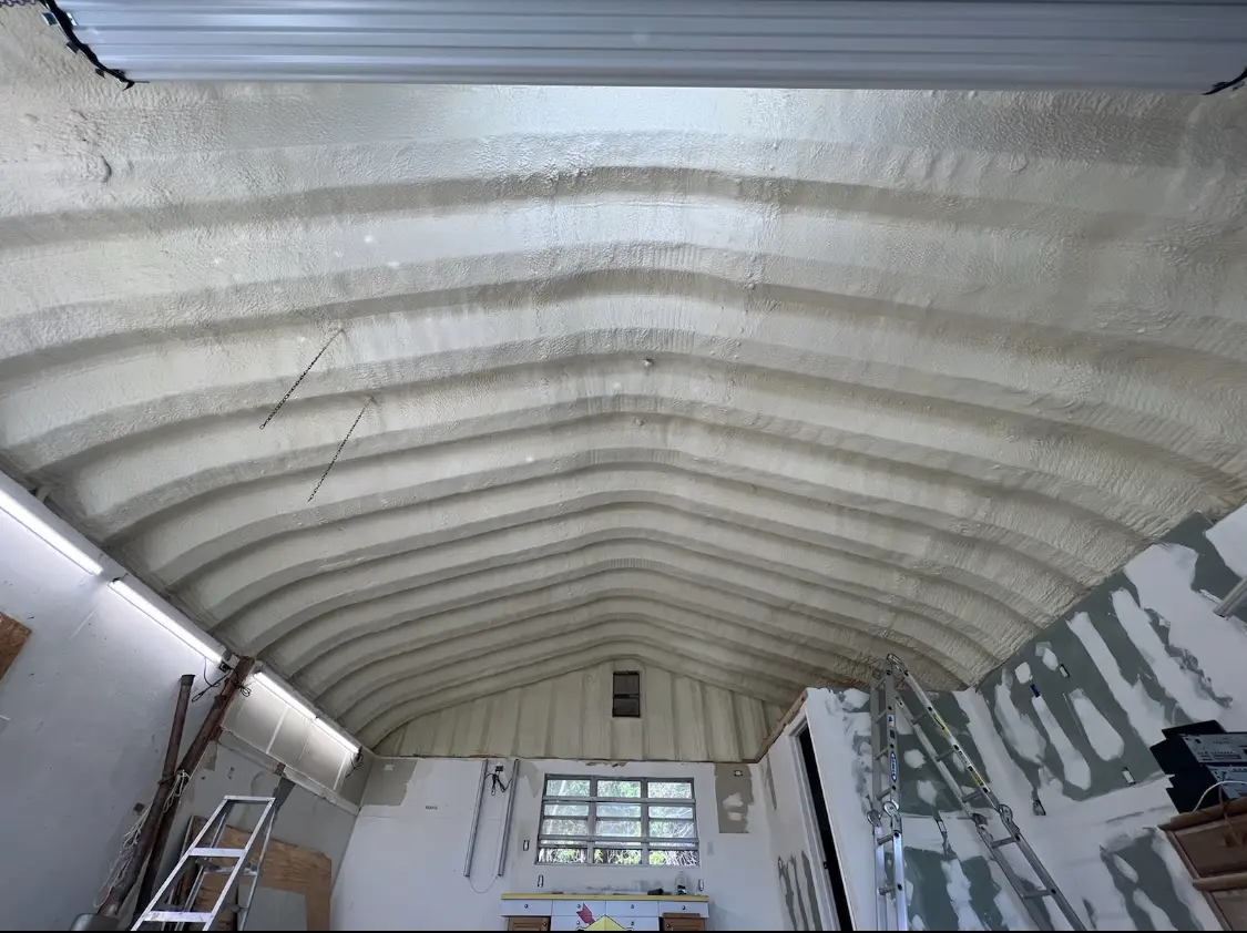 Spray polyurethane foam applied to the underside of a metal roof deck in Crandall